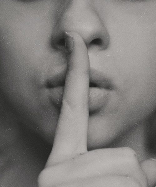 grayscale photo of woman doing silent hand sign